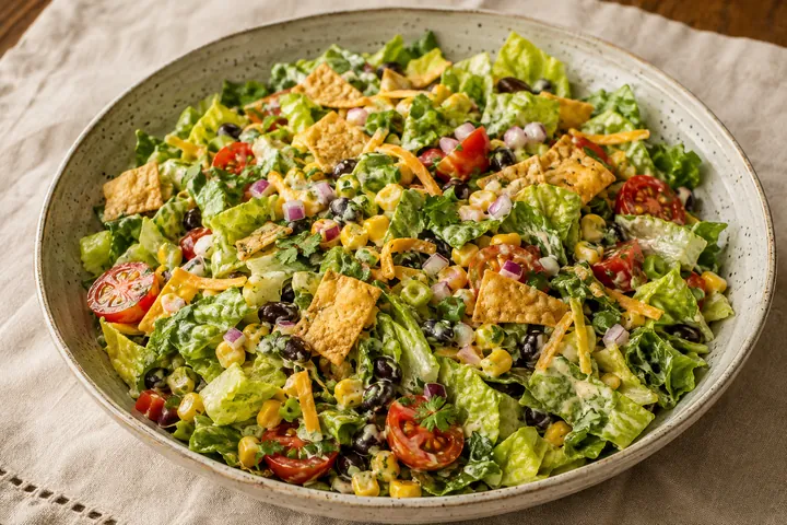 Jalapeño ranch salad with romaine, black beans, corn, tomatoes, red onion, cheddar, and tortilla crisps